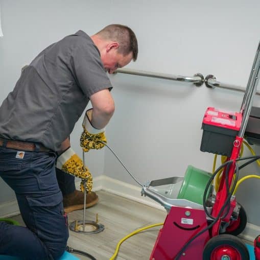 A technician uses advanced plumbing tools to inspect bathroom pipes with a camera device, as the monitor displays the pipe’s interior—improving repair accuracy.
