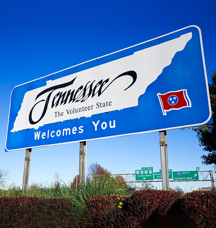 A large blue and white road sign reads