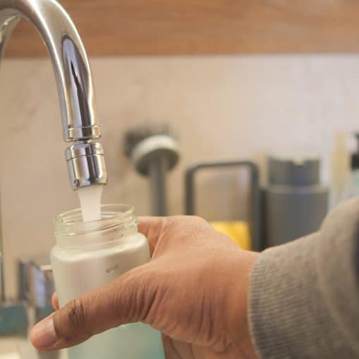 Filling a bottle with water from a faucet using hand gestures,