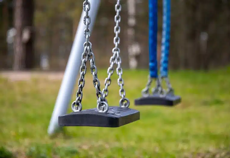 a playground swing set, a common feature in parks and recreational areas