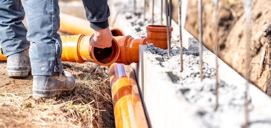 installation of a sewage plastic pipe during the construction of a house.