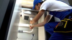 plumber repairing clogged drain