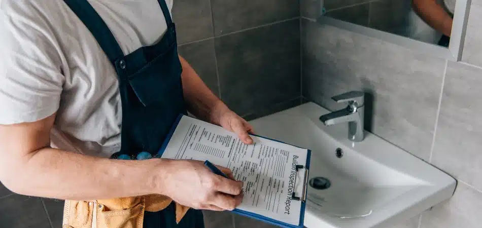 professional plumber checking maintenance plumbing checklist