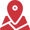 Red location pin icon overlaid on a stylized map, indicating a place or position marker.