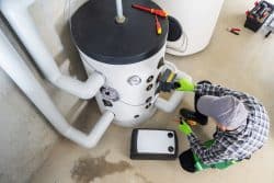 Top View of Professional Heating System Engineer Performing Scheduled Equipment Maintenance Check.