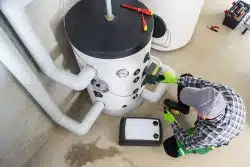 Top View of Professional Heating System Engineer Performing Scheduled Equipment Maintenance Check.