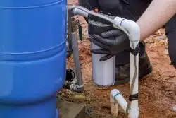 Worker maintenance work replaces at domestic water treatment residential line water filter